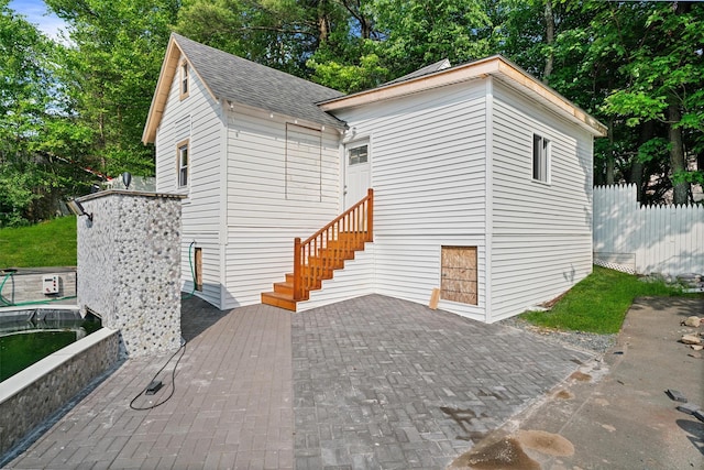 31 Forestburgh Rd, Monticello, NY 12701 - view of side of property featuring roof with shingles and a patio area