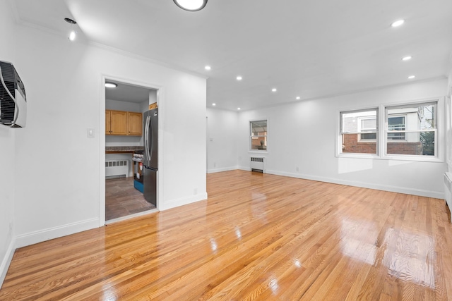 8043 Utopia Pkwy, Jamaica Estates, NY 11432 - unfurnished living room with radiator, light wood-type flooring, recessed lighting, and baseboards