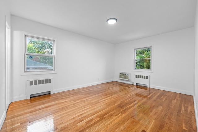 8043 Utopia Pkwy, Jamaica Estates, NY 11432 - spare room featuring radiator, light wood-type flooring, and baseboards