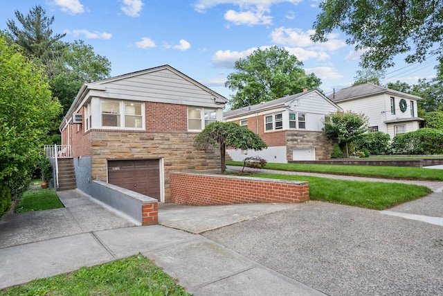 8043 Utopia Pkwy, Jamaica Estates, NY 11432 - view of front facade with concrete driveway, stone siding, and a garage