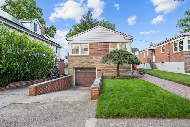 8043 Utopia Pkwy, Jamaica Estates, NY 11432 - view of front of house featuring concrete driveway, stone siding, an attached garage, and a front lawn