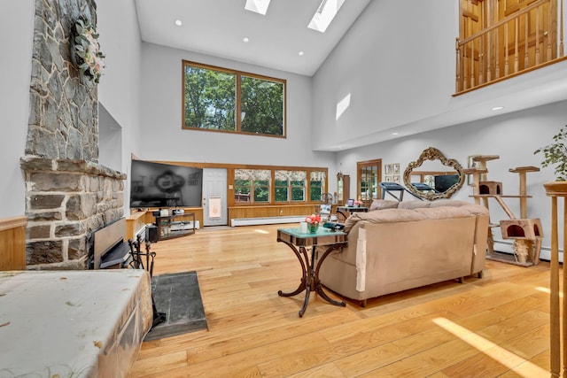 65 Oxford Springs Rd, Chester, NY 10918 - living area featuring high vaulted ceiling, a skylight, wood-type flooring, baseboard heating, and recessed lighting