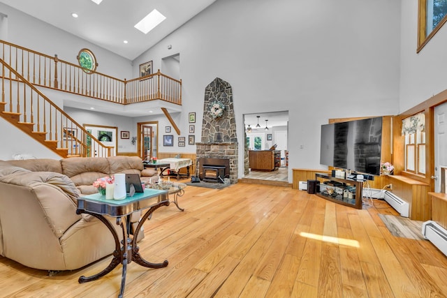 65 Oxford Springs Rd, Chester, NY 10918 - living room featuring a high ceiling, a skylight, hardwood / wood-style floors, stairs, and a baseboard radiator