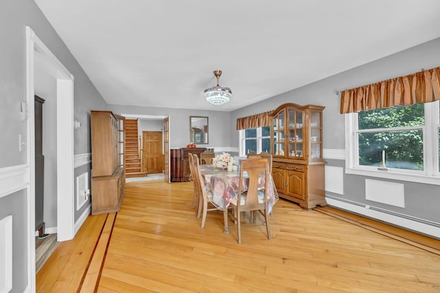 65 Oxford Springs Rd, Chester, NY 10918 - dining space with light wood-style flooring, a baseboard radiator, a chandelier, and a wainscoted wall
