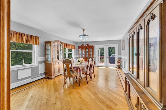 65 Oxford Springs Rd, Chester, NY 10918 - dining space with baseboard heating, light wood-style flooring, wainscoting, french doors, and a chandelier