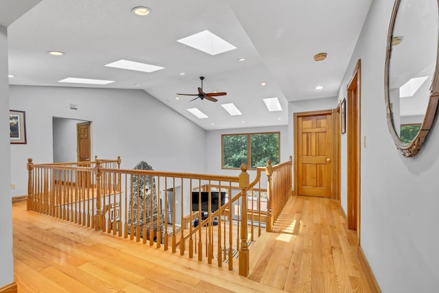 65 Oxford Springs Rd, Chester, NY 10918 - hallway featuring a skylight, an upstairs landing, light wood finished floors, vaulted ceiling, and recessed lighting