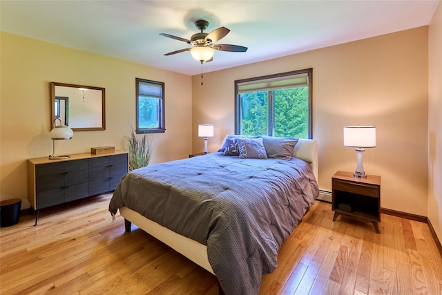 99 Dietz Rd, Jeffersonville, NY 12748 - bedroom featuring light wood-style flooring, baseboard heating, and a ceiling fan
