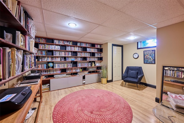 99 Dietz Rd, Jeffersonville, NY 12748 - office space with a paneled ceiling, wood finished floors, and wall of books