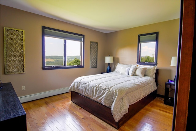 99 Dietz Rd, Jeffersonville, NY 12748 - bedroom with a baseboard heating unit and light wood-style floors