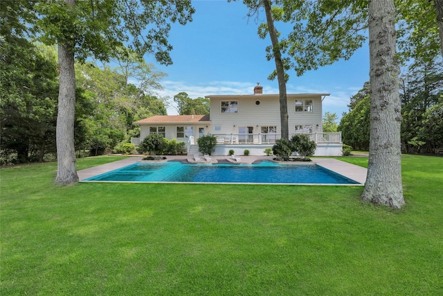2000 Beebe Dr, Cutchogue, NY 11935 - rear view of house featuring a lawn, a chimney, an outdoor pool, and a patio area