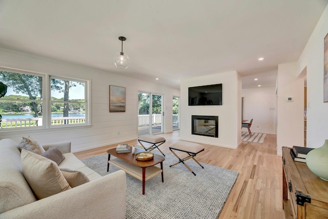 2000 Beebe Dr, Cutchogue, NY 11935 - living area featuring light wood-style flooring, a glass covered fireplace, and recessed lighting