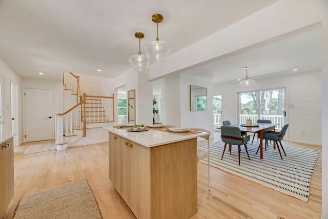 2000 Beebe Dr, Cutchogue, NY 11935 - kitchen with light wood-style flooring, a kitchen island, light countertops, decorative light fixtures, and recessed lighting