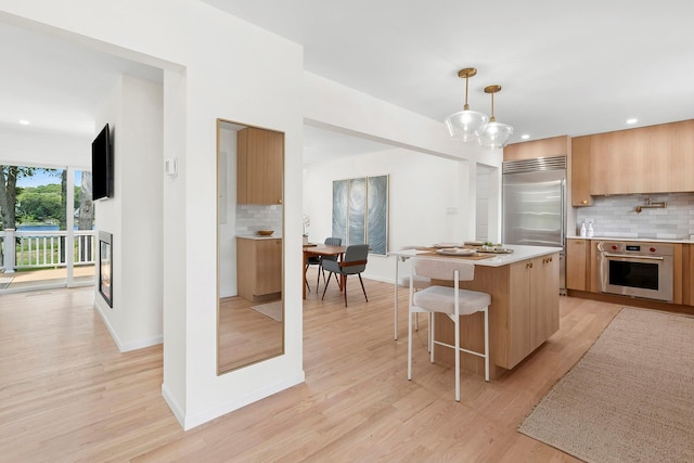 2000 Beebe Dr, Cutchogue, NY 11935 - kitchen featuring modern cabinets, tasteful backsplash, stainless steel appliances, light countertops, and a kitchen island
