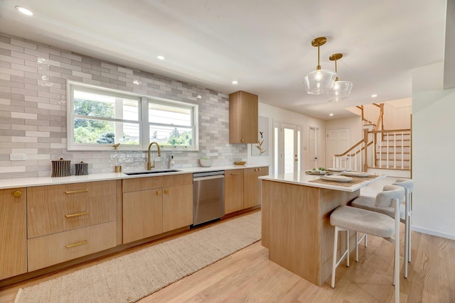 2000 Beebe Dr, Cutchogue, NY 11935 - kitchen featuring decorative backsplash, light countertops, a kitchen breakfast bar, light wood-style flooring, and stainless steel dishwasher