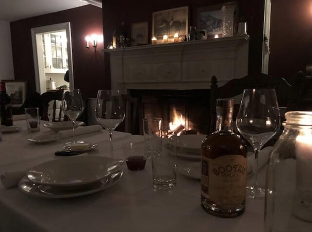 dining room featuring a lit fireplace