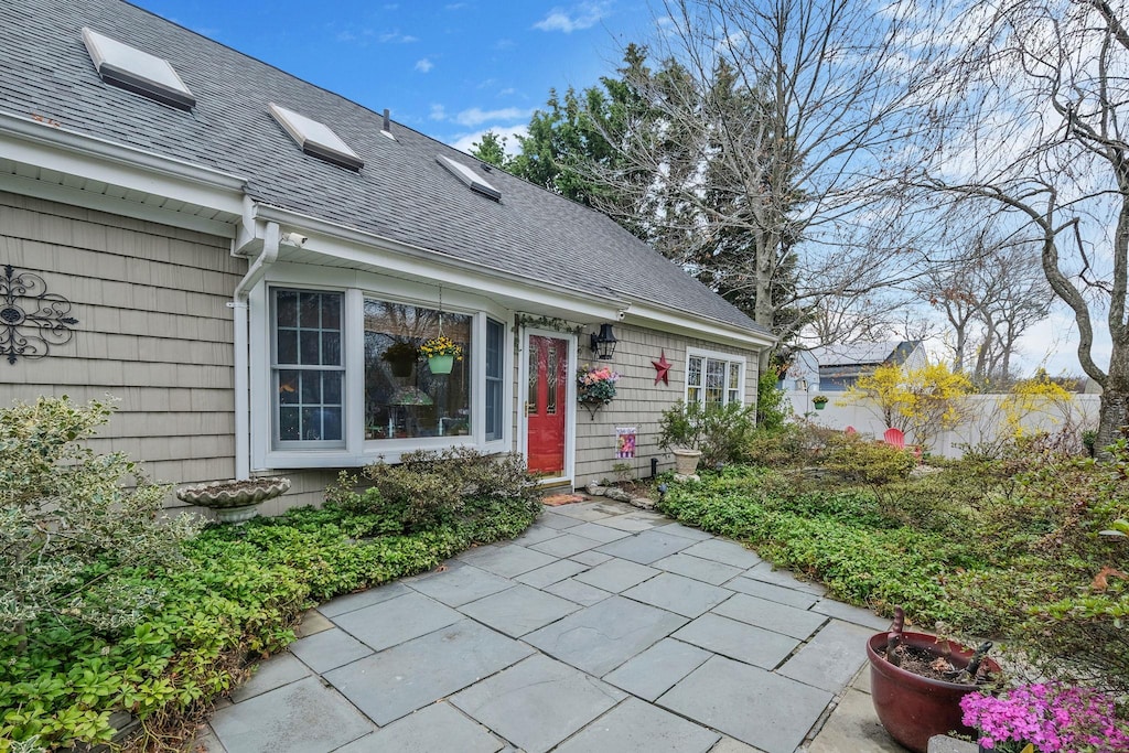 9 Jewel Dr, Holtsville, NY 11742 - doorway to property with a patio and a shingled roof