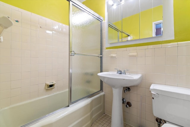 102-30 66th Rd Unit 4B, Forest Hills, NY 11375 - full bath with tile walls, enclosed tub / shower combo, toilet, and a wainscoted wall