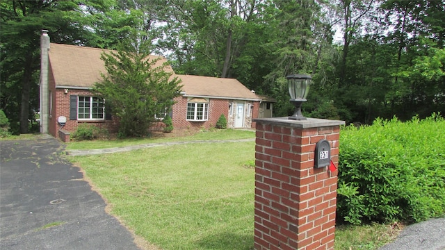 231 Lakeview Rd, Wappingers Falls, NY 12590 - view of front of home featuring a front lawn, brick siding, and a chimney
