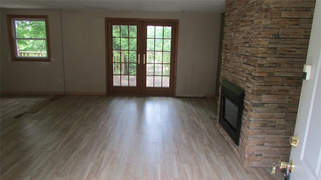 231 Lakeview Rd, Wappingers Falls, NY 12590 - unfurnished living room featuring plenty of natural light, light wood finished floors, french doors, and baseboards