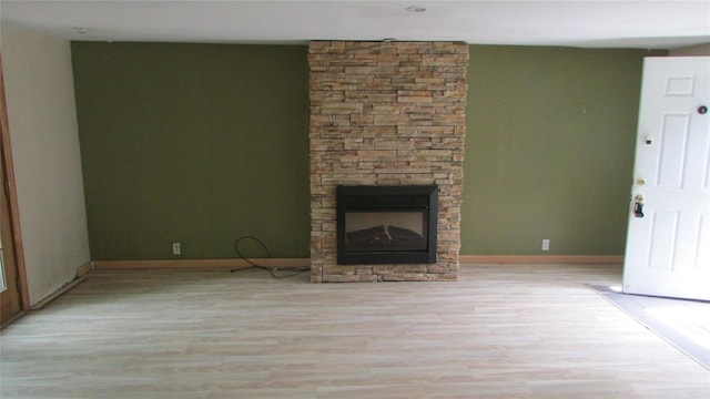 231 Lakeview Rd, Wappingers Falls, NY 12590 - unfurnished living room featuring wood finished floors, a stone fireplace, and baseboards