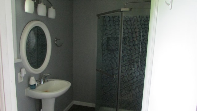 231 Lakeview Rd, Wappingers Falls, NY 12590 - bathroom featuring a stall shower, a sink, and baseboards