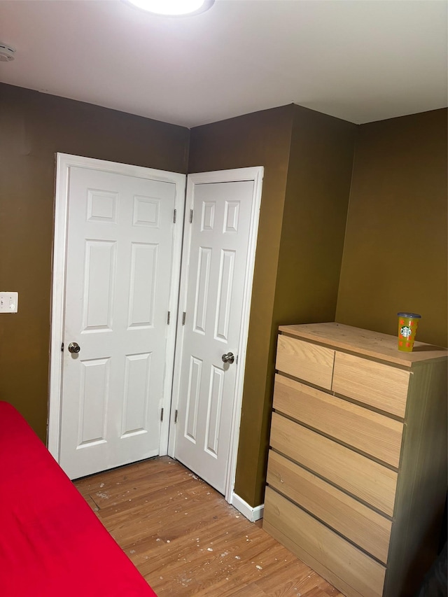 44 Chapman Pl, Bay Shore, NY 11706 - unfurnished bedroom featuring wood finished floors and baseboards