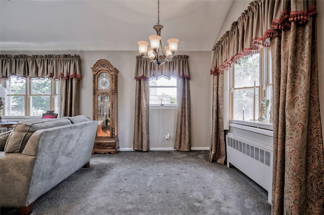 30 W 12th St, Huntington Station, NY 11746 - living area with radiator heating unit, a chandelier, carpet, baseboards, and vaulted ceiling