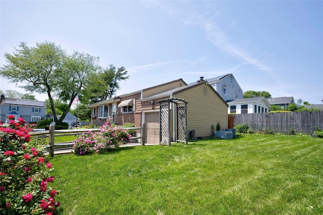 30 W 12th St, Huntington Station, NY 11746 - back of property with central AC unit and an attached garage