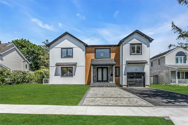 9 Vista Ln, Levittown, NY 11756 - modern farmhouse with asphalt driveway, a garage, a front yard, and stone siding