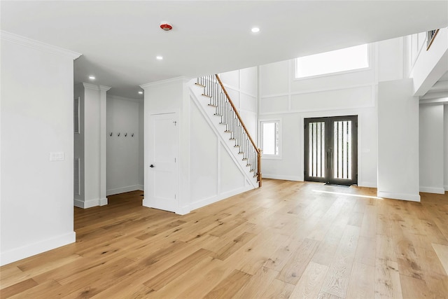 9 Vista Ln, Levittown, NY 11756 - foyer featuring stairway, light wood-type flooring, crown molding, recessed lighting, and baseboards