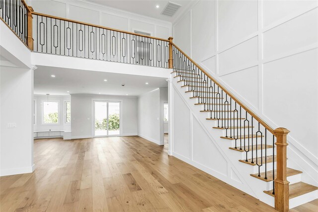 9 Vista Ln, Levittown, NY 11756 - stairway with a towering ceiling, wood finished floors, baseboards, recessed lighting, and crown molding