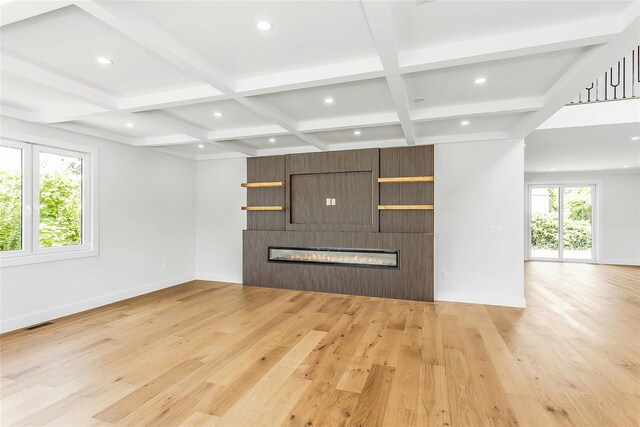 9 Vista Ln, Levittown, NY 11756 - unfurnished living room featuring a fireplace, baseboards, light wood-style flooring, coffered ceiling, and beamed ceiling