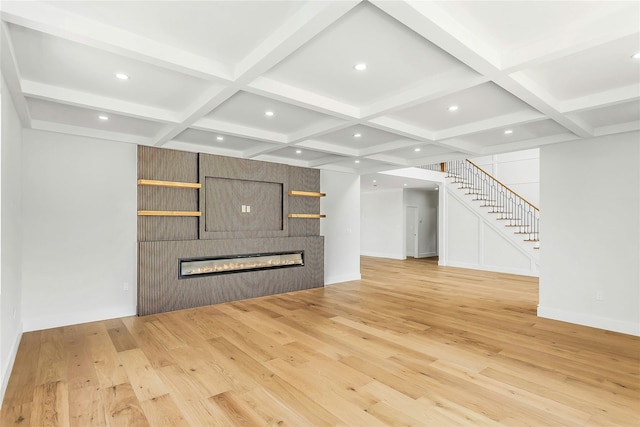 9 Vista Ln, Levittown, NY 11756 - unfurnished living room featuring coffered ceiling, light wood-style floors, stairway, a fireplace, and beam ceiling