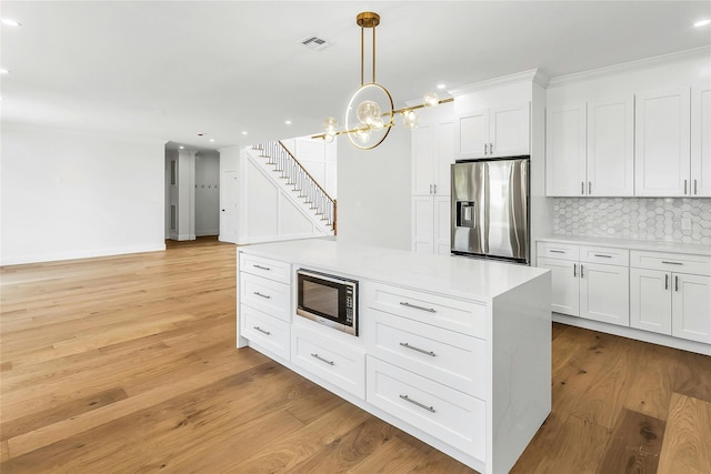 9 Vista Ln, Levittown, NY 11756 - kitchen featuring stainless steel appliances, decorative backsplash, recessed lighting, white cabinetry, and light countertops