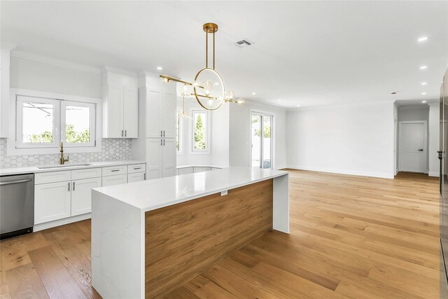 9 Vista Ln, Levittown, NY 11756 - kitchen with a sink, stainless steel dishwasher, tasteful backsplash, white cabinets, and recessed lighting