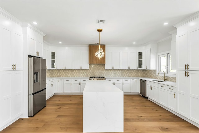 9 Vista Ln, Levittown, NY 11756 - kitchen featuring stainless steel appliances, a sink, glass insert cabinets, tasteful backsplash, and recessed lighting