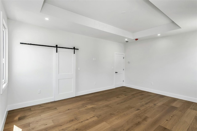 9 Vista Ln, Levittown, NY 11756 - spare room with recessed lighting, a barn door, baseboards, wood finished floors, and a raised ceiling