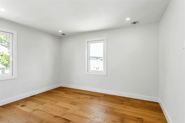 9 Vista Ln, Levittown, NY 11756 - unfurnished room featuring baseboards, light wood-style floors, and recessed lighting