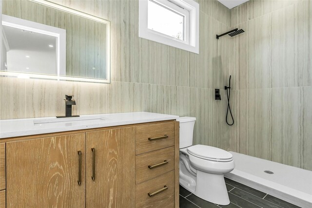 9 Vista Ln, Levittown, NY 11756 - bathroom featuring toilet, a tile shower, vanity, tile walls, and tile patterned floors