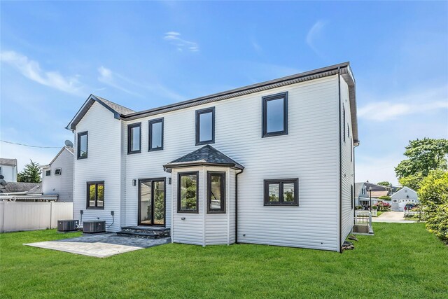 9 Vista Ln, Levittown, NY 11756 - back of house with central air condition unit and a patio