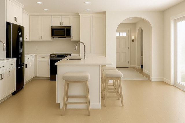8 Newburgh Rd, Patterson, NY 12563 - kitchen featuring stainless steel appliances, a sink, a breakfast bar area, arched walkways, and recessed lighting