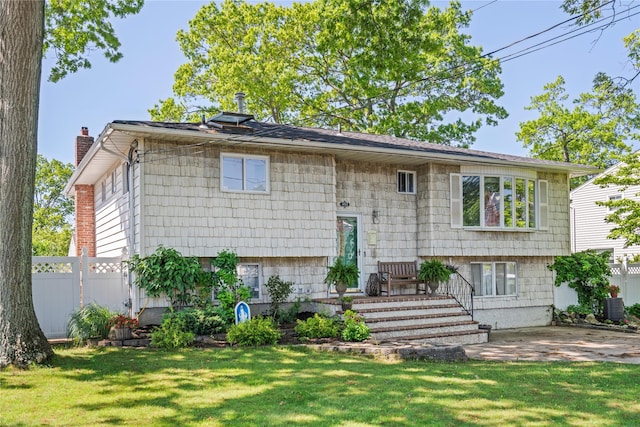 402 Chelsea Ave, West Babylon, NY 11704 - bi-level home featuring a chimney, cooling unit, and a patio