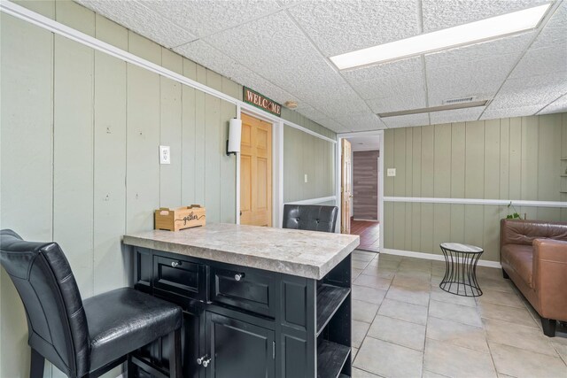 402 Chelsea Ave, West Babylon, NY 11704 - kitchen featuring open floor plan, dark cabinets, light countertops, a peninsula, and light tile patterned floors