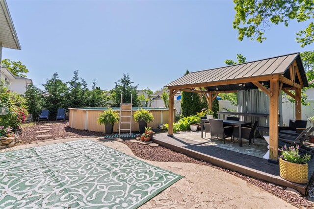 402 Chelsea Ave, West Babylon, NY 11704 - view of patio / terrace with a gazebo, an outdoor pool, and outdoor dining space
