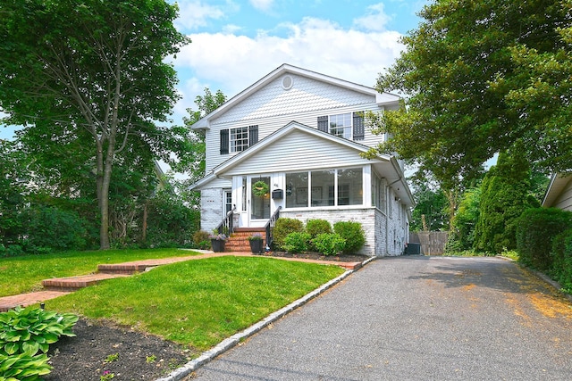 46 Gilbert St, Northport, NY 11768 - view of front facade featuring asphalt driveway and a sunroom
