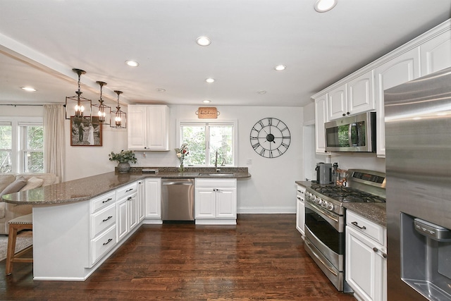 46 Gilbert St, Northport, NY 11768 - kitchen featuring stainless steel appliances, a sink, a peninsula, healthy amount of natural light, and recessed lighting