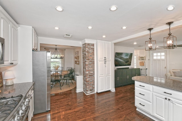 46 Gilbert St, Northport, NY 11768 - kitchen with stainless steel appliances, a chandelier, plenty of natural light, dark stone countertops, and recessed lighting