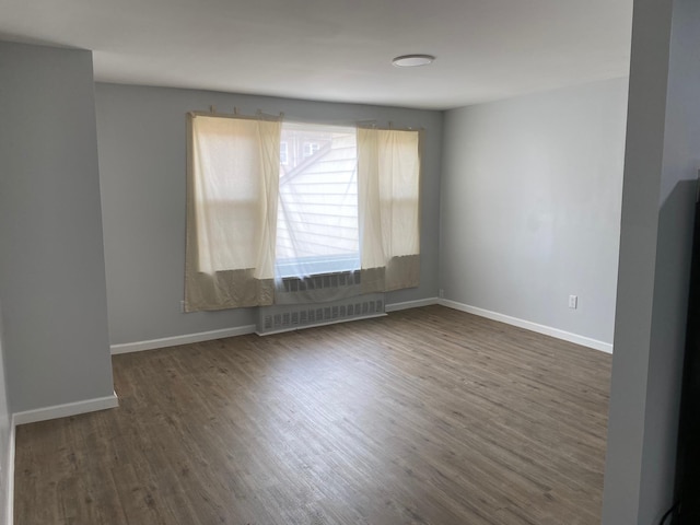 644 Autumn Ave, Brooklyn, NY 11208 - spare room with dark wood finished floors and radiator heating unit