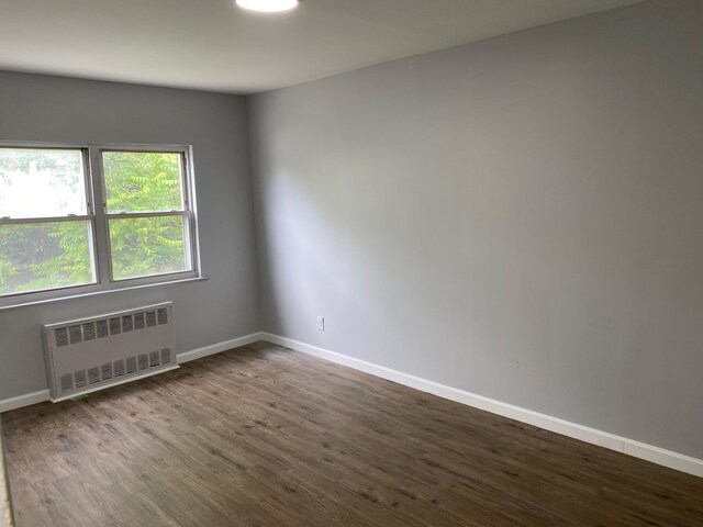 644 Autumn Ave, Brooklyn, NY 11208 - unfurnished room with radiator and dark wood-type flooring