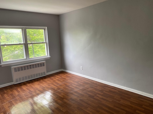 644 Autumn Ave, Brooklyn, NY 11208 - spare room with radiator heating unit and dark wood finished floors